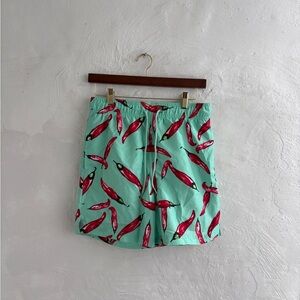 George Men's novelty swim trunks in a green color with a red chili pepper print